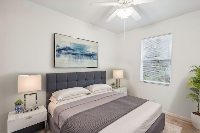 bedroom with a ceiling fan and baseboards