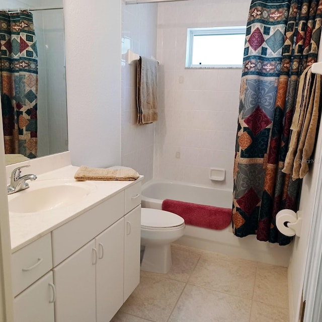 full bathroom with toilet, tile patterned floors, shower / bath combo with shower curtain, and vanity