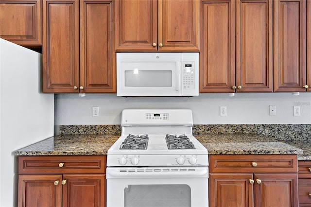 kitchen with white appliances and stone counters