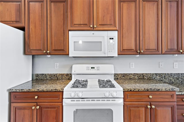 134 Savona Way N, Venice, FL 34275 - kitchen featuring white appliances, brown cabinets, and stone countertops