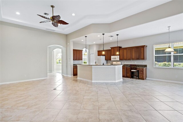 134 Savona Way N, Venice, FL 34275 - kitchen featuring white appliances, a ceiling fan, arched walkways, recessed lighting, and a tray ceiling