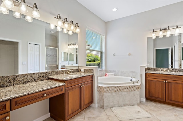 bathroom with tile patterned floors, vanity, and shower with separate bathtub