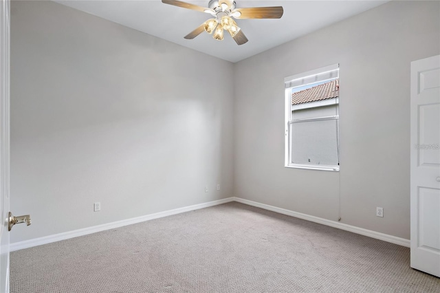 spare room with light carpet and ceiling fan