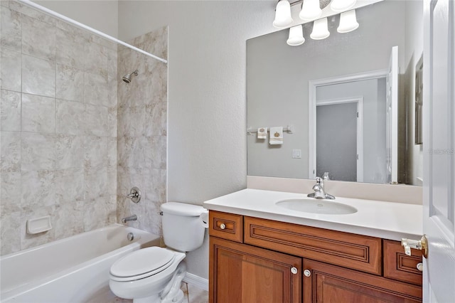 full bathroom featuring vanity, toilet, and tiled shower / bath