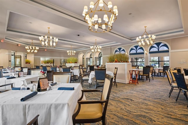 carpeted dining space with a tray ceiling and crown molding