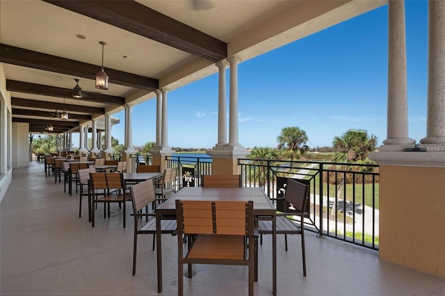 view of patio with a water view and a balcony