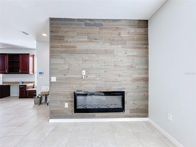 room details featuring a textured ceiling, built in desk, and wood walls