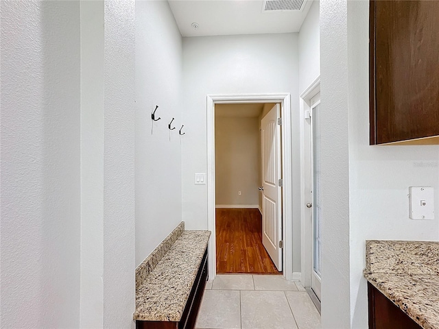 corridor with light hardwood / wood-style flooring