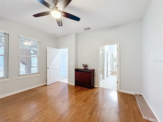 spare room with hardwood / wood-style flooring and ceiling fan