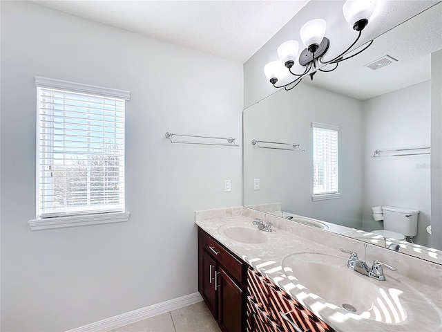 bathroom featuring tile patterned floors, vanity, a textured ceiling, and toilet