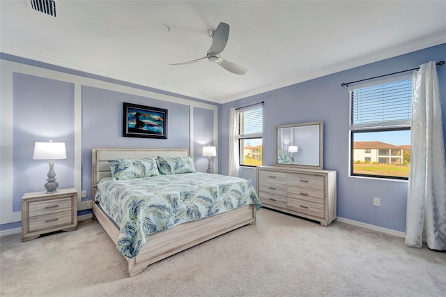 carpeted bedroom with crown molding and ceiling fan