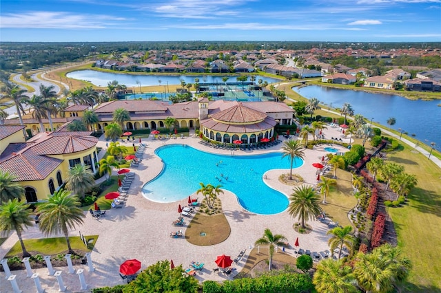 view of pool with a water view and a patio