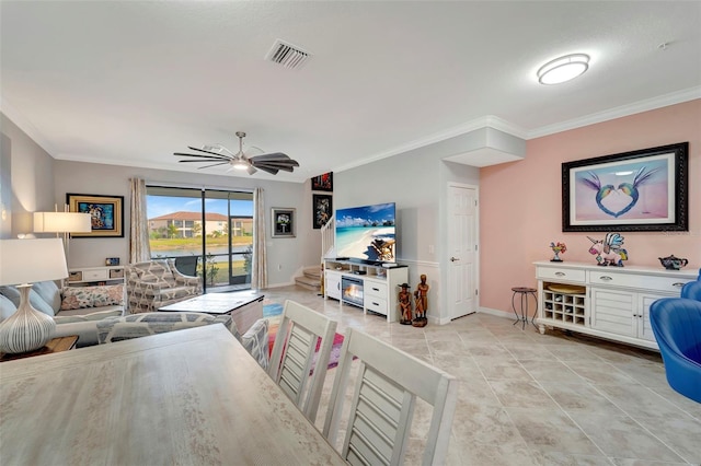 living room with ceiling fan, ornamental molding, and light tile patterned floors