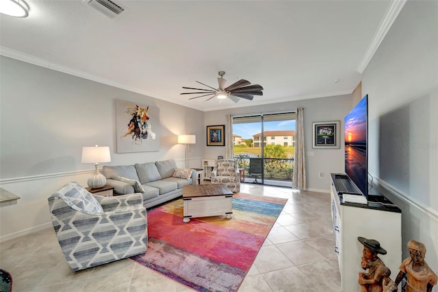 tiled living room with ceiling fan and ornamental molding