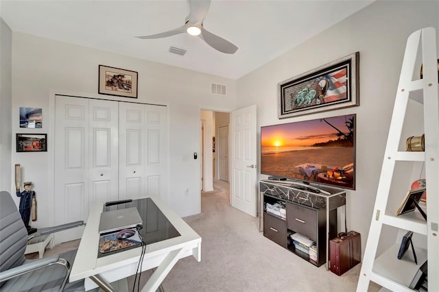 carpeted office space with ceiling fan