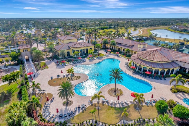 view of swimming pool with a water view and a patio