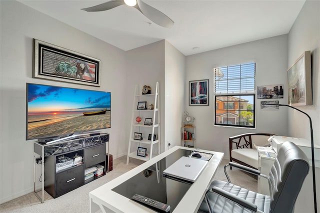 carpeted office featuring ceiling fan