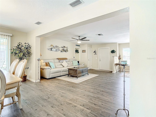 living room featuring hardwood / wood-style flooring and ceiling fan