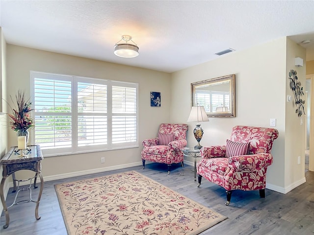 sitting room featuring hardwood / wood-style floors and a textured ceiling