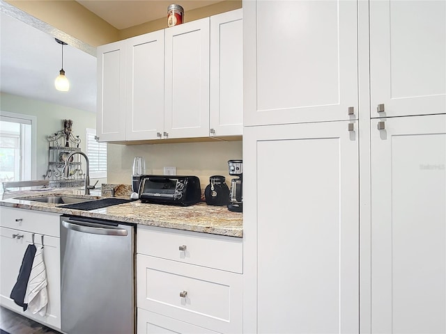 kitchen with white cabinetry, sink, stainless steel dishwasher, and decorative light fixtures