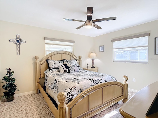 bedroom featuring ceiling fan and multiple windows