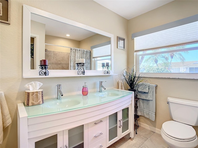 bathroom featuring walk in shower, tile patterned flooring, vanity, and toilet