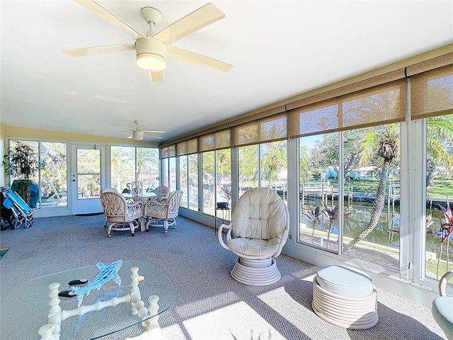 sunroom / solarium featuring ceiling fan