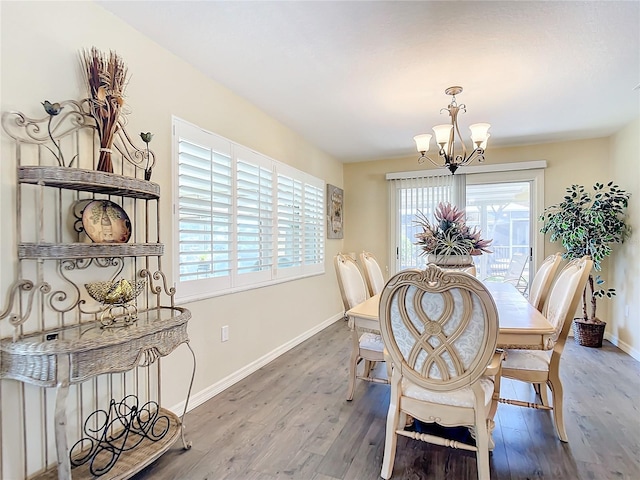 4 Windsor Dr, Englewood, FL 34223 - dining area with baseboards, a notable chandelier, and wood finished floors