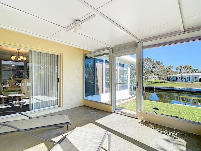 4 Windsor Dr, Englewood, FL 34223 - unfurnished sunroom featuring a water view and a chandelier