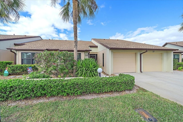 1211 Capri Isles Blvd Unit 58, Venice, FL 34292 - single story home with stucco siding, a garage, concrete driveway, and a shingled roof