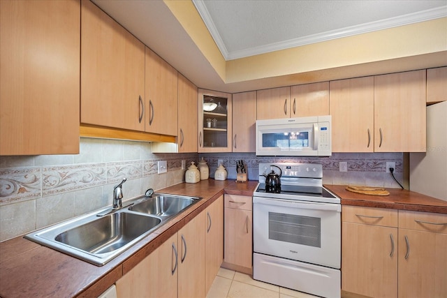 kitchen featuring light tile patterned flooring, white appliances, ornamental molding, and light brown cabinetry