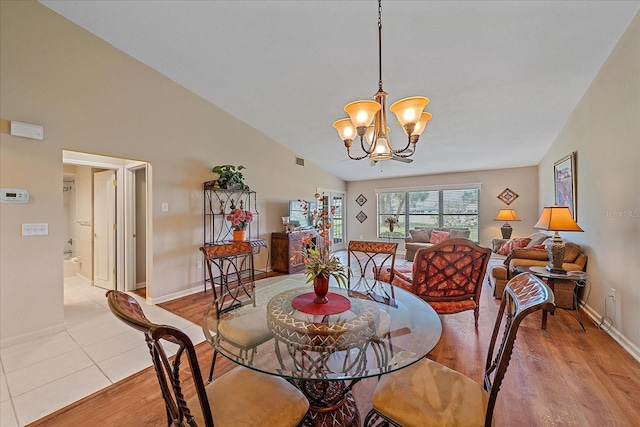1211 Capri Isles Blvd Unit 58, Venice, FL 34292 - dining space featuring light wood-style floors, a chandelier, and vaulted ceiling