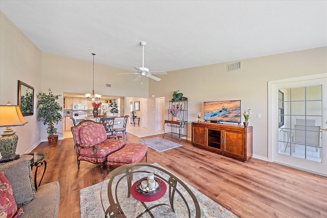 1211 Capri Isles Blvd Unit 58, Venice, FL 34292 - living area with light wood-style floors, ceiling fan, a chandelier, and high vaulted ceiling