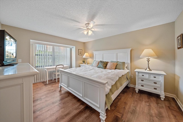 bedroom with ceiling fan, dark hardwood / wood-style flooring, and a textured ceiling