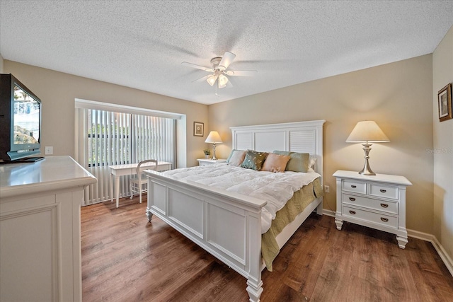1211 Capri Isles Blvd Unit 58, Venice, FL 34292 - bedroom with dark wood-type flooring, a textured ceiling, and a ceiling fan
