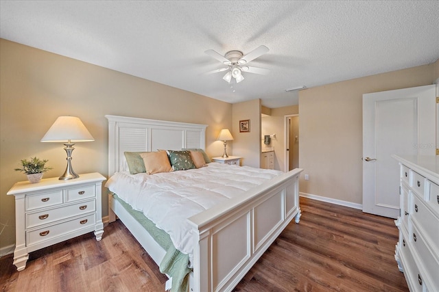 bedroom with ceiling fan, dark hardwood / wood-style flooring, and a textured ceiling