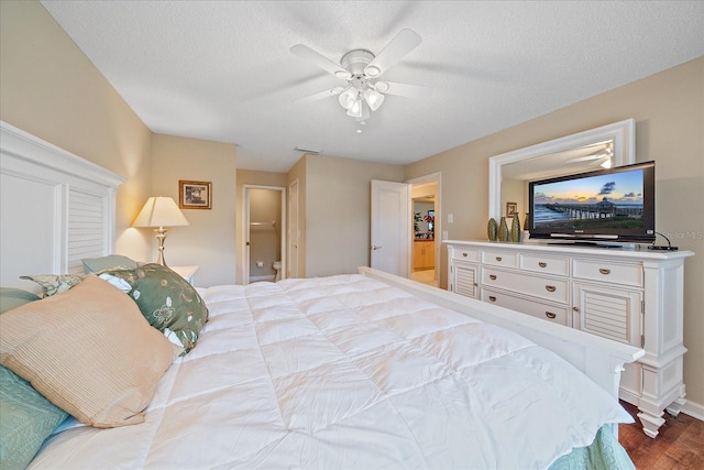 bedroom featuring ceiling fan, light wood-type flooring, and a textured ceiling