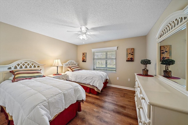 1211 Capri Isles Blvd Unit 58, Venice, FL 34292 - bedroom with dark wood-style flooring, a ceiling fan, and a textured ceiling