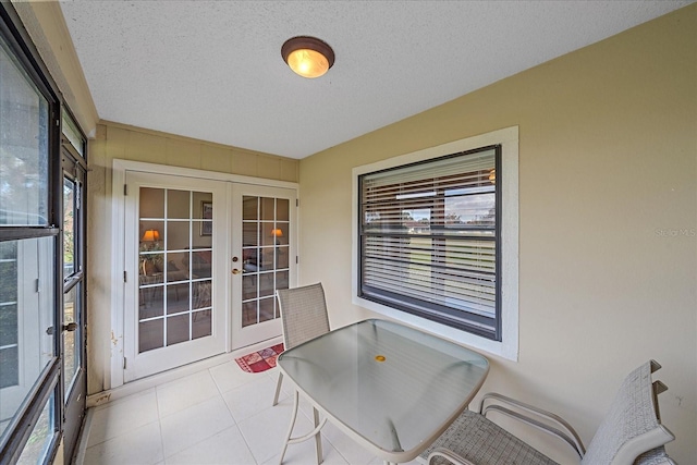 sunroom / solarium with a wealth of natural light and french doors