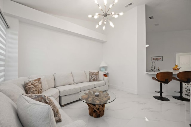 living room featuring sink and a notable chandelier