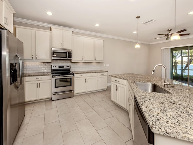 kitchen with hanging light fixtures, sink, ceiling fan, light stone countertops, and appliances with stainless steel finishes