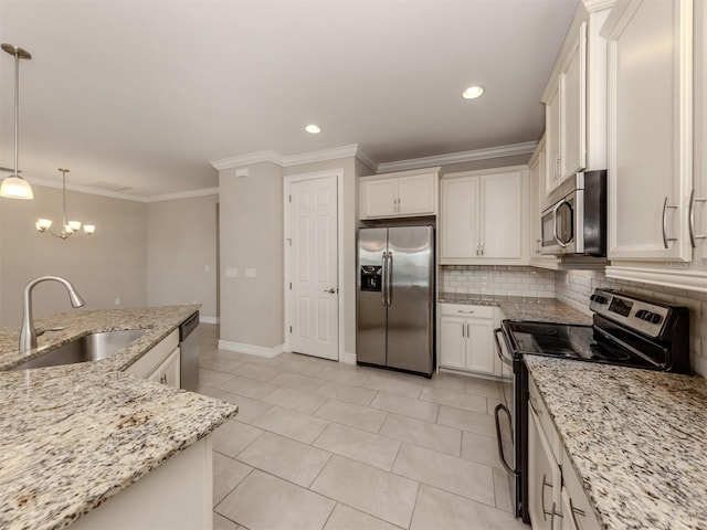 kitchen with white cabinetry, sink, stainless steel appliances, light stone counters, and decorative light fixtures