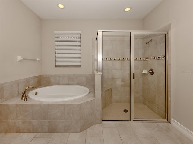 bathroom featuring tile patterned flooring and separate shower and tub