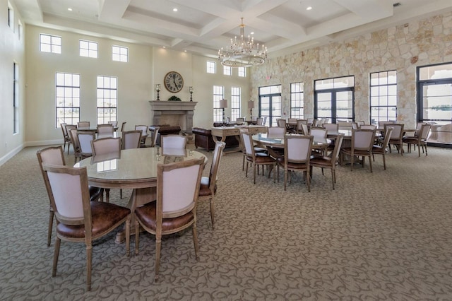 dining room with a healthy amount of sunlight, carpet floors, and a high ceiling