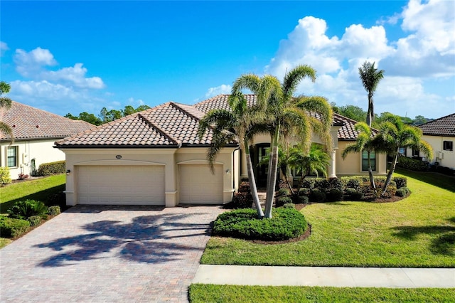 mediterranean / spanish-style house with a garage and a front lawn