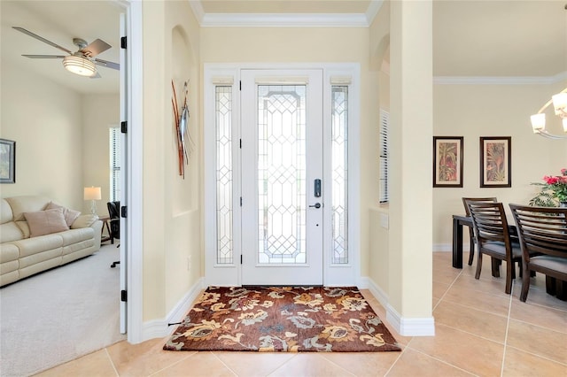 entryway featuring ceiling fan, crown molding, light tile patterned floors, and plenty of natural light