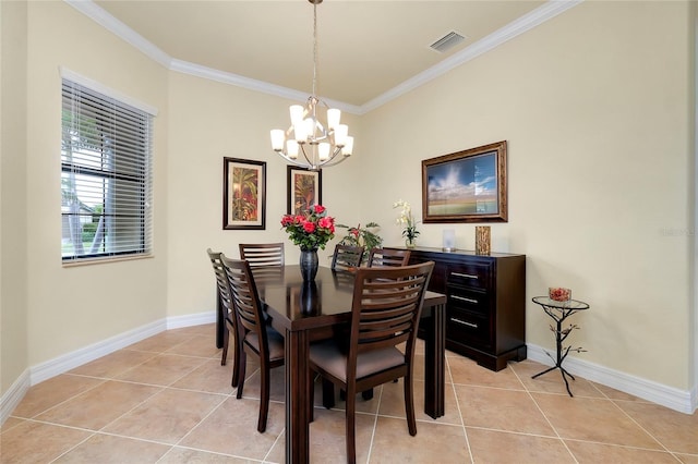 tiled dining space featuring a chandelier and ornamental molding