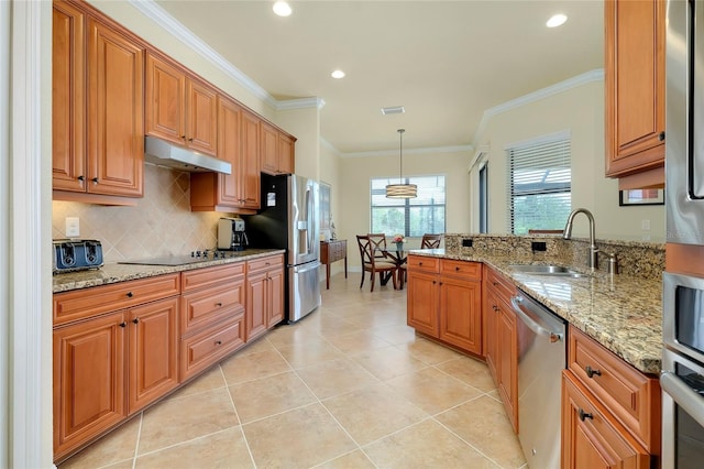 kitchen featuring sink, light tile patterned floors, appliances with stainless steel finishes, decorative light fixtures, and light stone counters