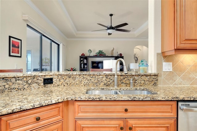 kitchen featuring dishwasher, ornamental molding, sink, and a tray ceiling