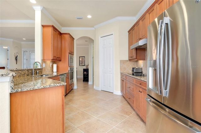 kitchen featuring sink, decorative backsplash, appliances with stainless steel finishes, light tile patterned flooring, and light stone counters